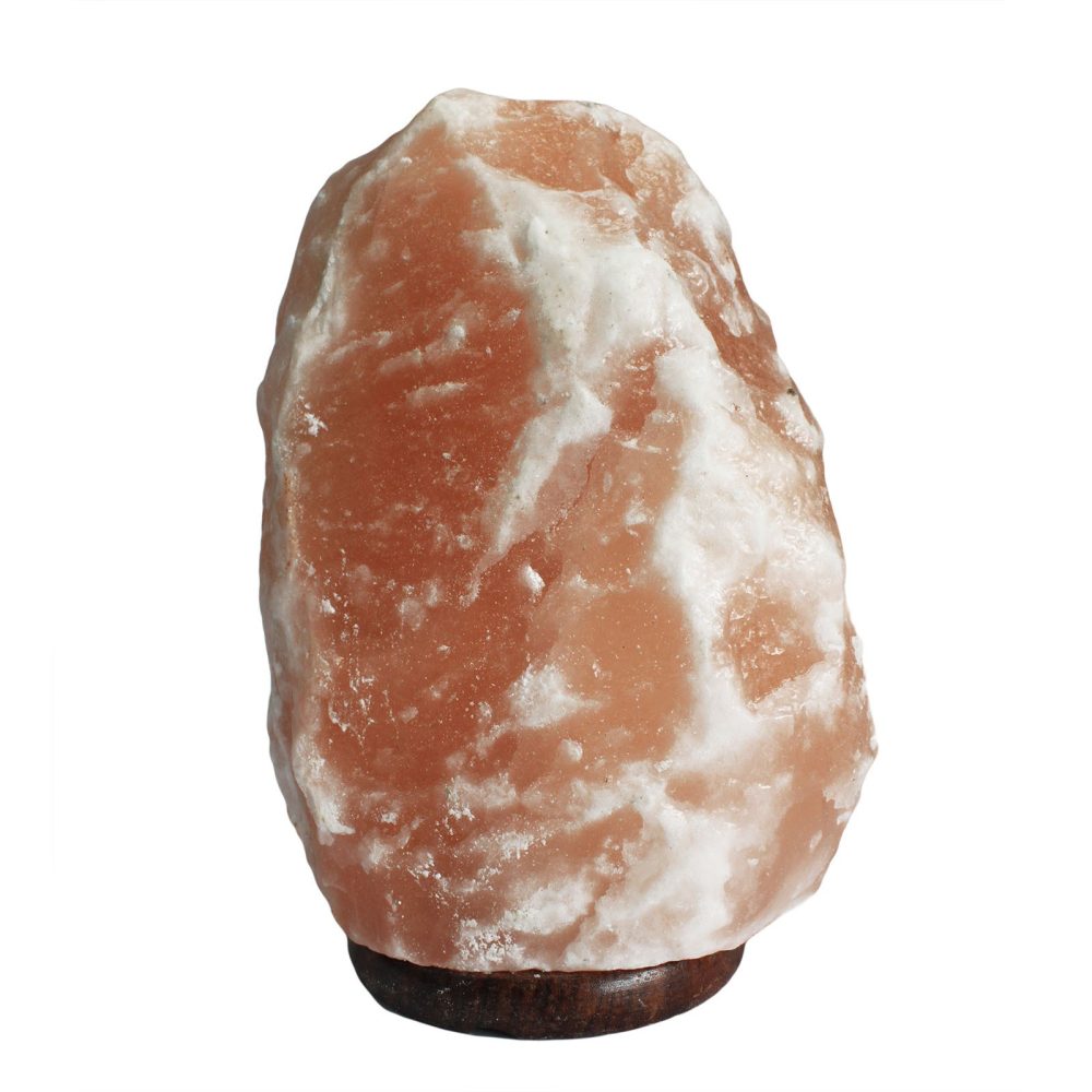 A jagged pink and white salt lamp rests on a smooth wooden base, set against a plain white background.