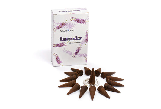 Incense cones arranged in a circle around a metal holder. A box labeled "STAMFORD INC. Lavender 15 incense cones" with lavender illustrations stands upright behind them.