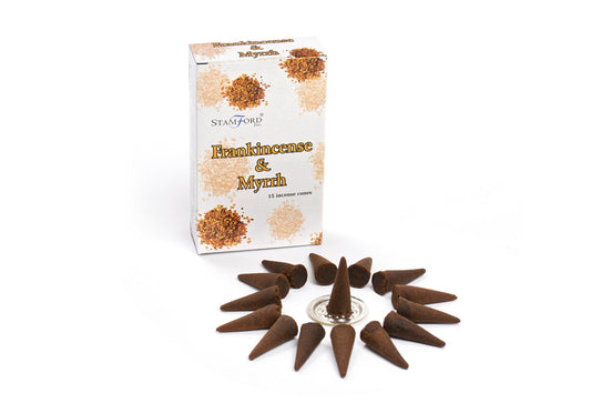 Incense cones arranged in a circle surround a silver holder. A box labeled "Stamford Inc. Frankincense & Myrrh, 15 incense cones" with brown textures stands nearby.