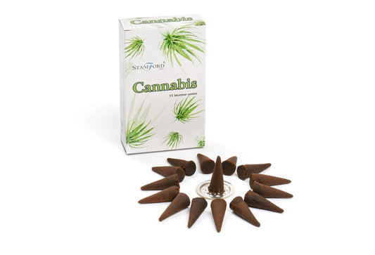 Box labeled "Stamford Inc. Cannabis 15 incense cones" beside arranged brown incense cones on a white surface, forming a circle. Cones point inward, one on a silver holder in center.