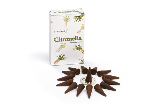Incense cones form a circle around a central cone on a holder. A nearby box labeled "Stamford Citronella 15 incense cones" features citronella plant illustrations.