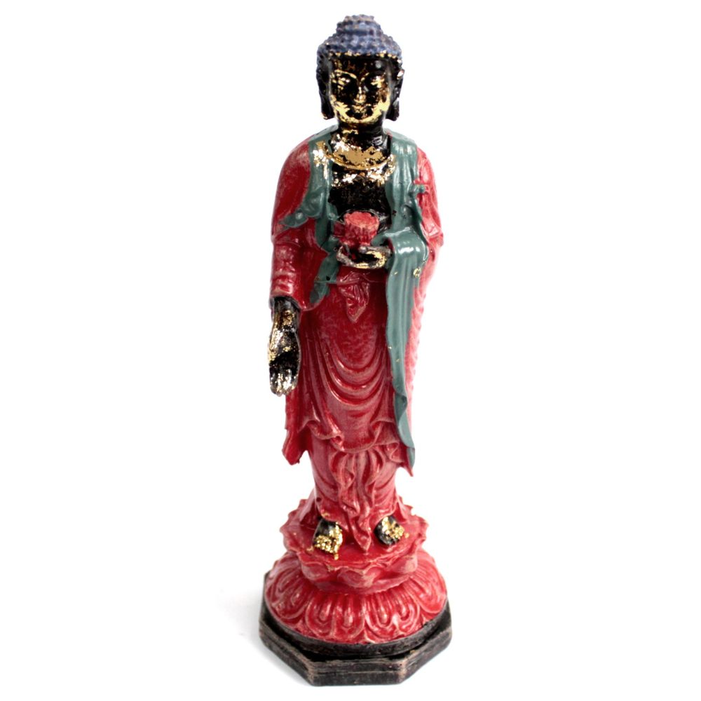 A painted statue depicts a standing figure holding an object, draped in red and green robes, featuring gold accents. It stands on a decorative base against a plain white background.