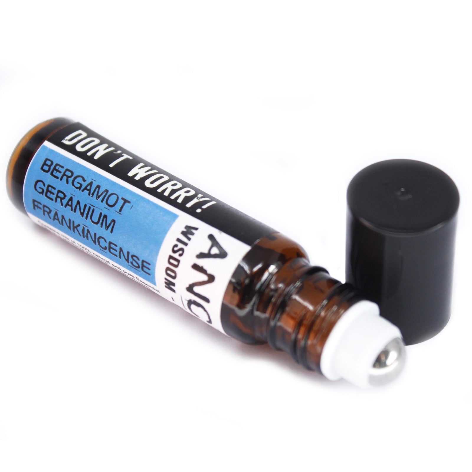 A small brown bottle of essential oil lays horizontally with its black cap off, on a white background. "DON'T WORRY! BERGAMOT GERANIUM FRANKINCENSE - ANC WISDOM" is printed on the bottle.