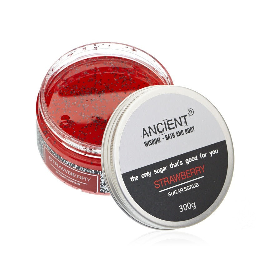 Strawberry sugar scrub in a clear jar sits next to its open lid, which reads "ANCIENT WISDOM - BATH AND BODY the only sugar that's good for you STRAWBERRY SUGAR SCRUB 300g."