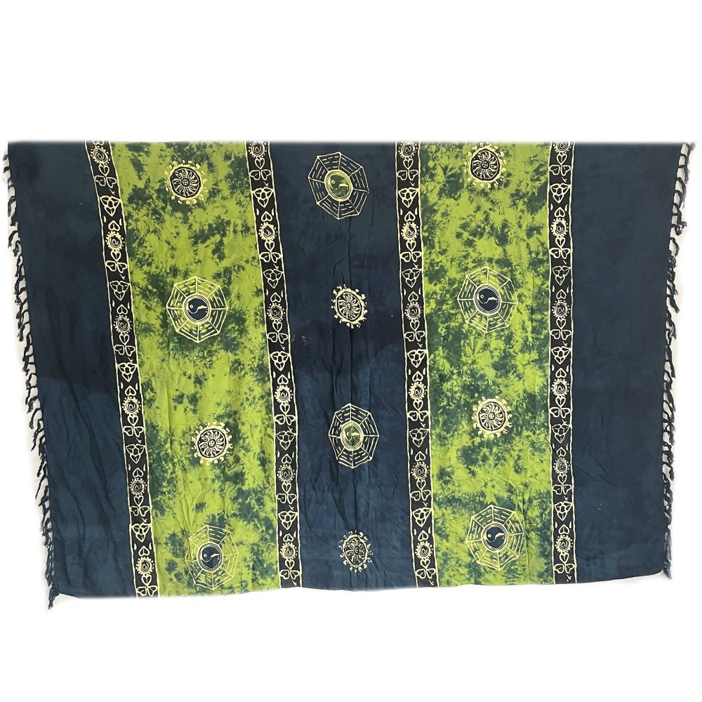 A rectangular textile hangs against a white background.  It displays a tie-dye pattern of dark teal and lime green, overlaid with repeating gold symbols.