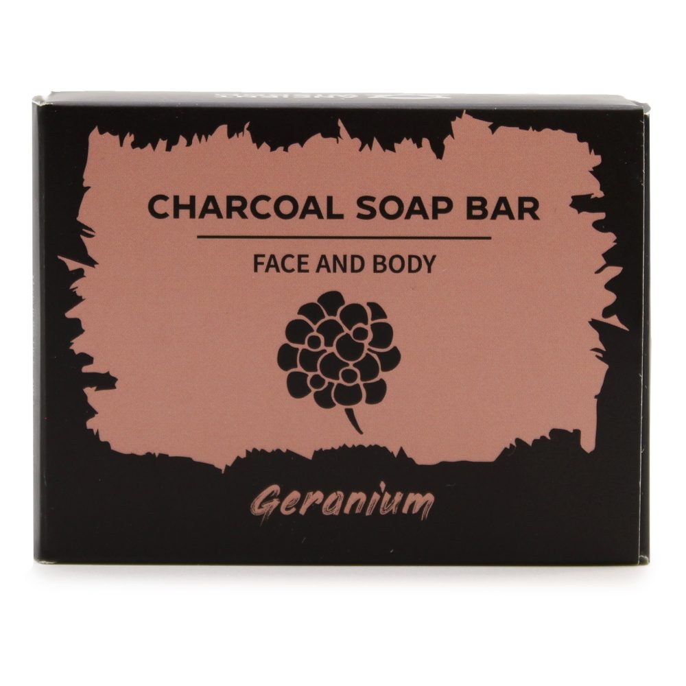 A black box displays "CHARCOAL SOAP BAR," "FACE AND BODY," and "Geranium" around a stylized geranium flower image printed on a reddish-brown, textured rectangle.