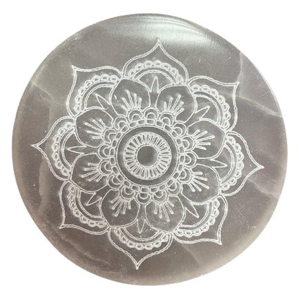 A translucent, gray disc displays a stylized, etched white lotus flower design. The flower's center is circular with radiating patterns.
