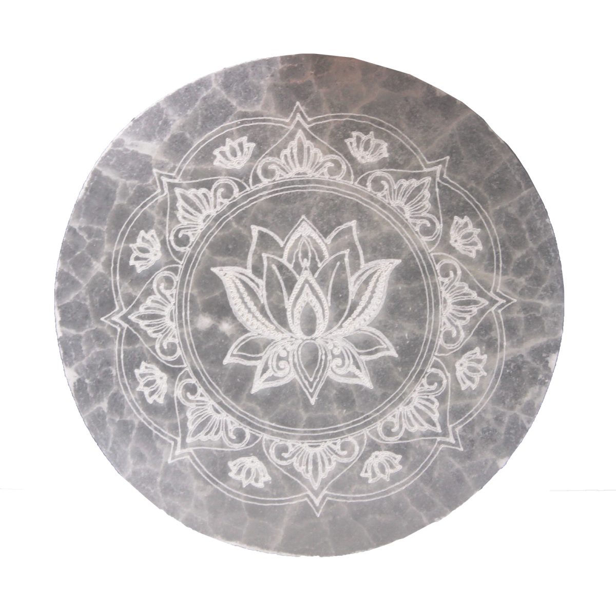 A circular, gray stone slab displays a white lotus flower mandala design etched into its surface. The lotus is centered, surrounded by a circular pattern with floral elements.