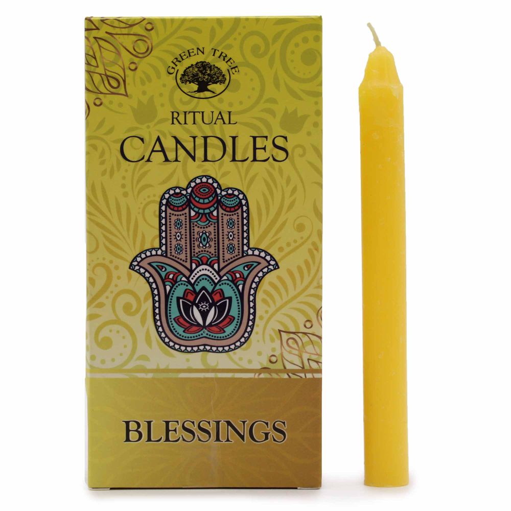 A yellow candle sits next to a box of "GREEN TREE RITUAL CANDLES" with a hamsa design on the front and the word "BLESSINGS" at the bottom, all against a white background.