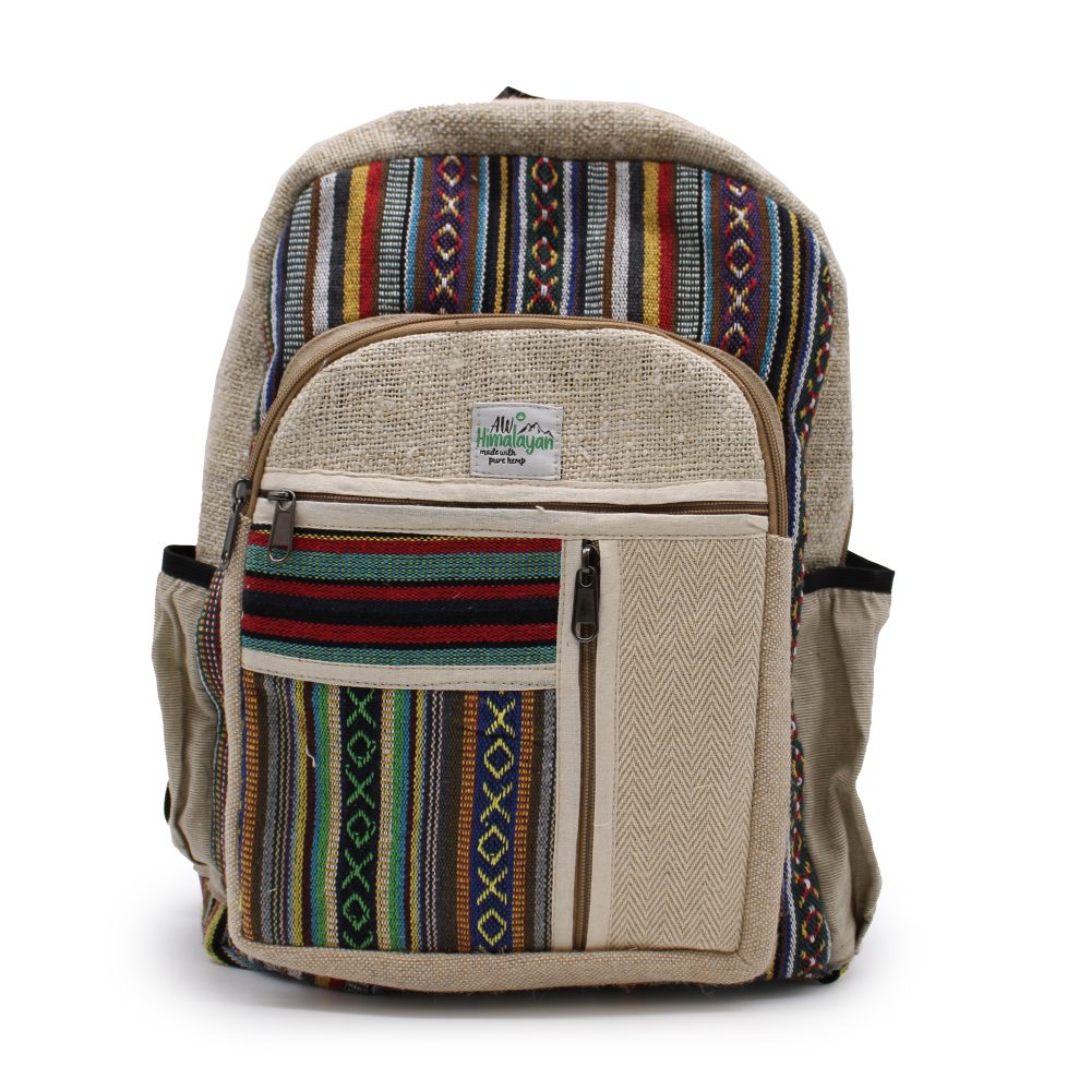 A hemp backpack, labelled "Himalayan pure hemp", sits upright against a white background, displaying colorful geometric patterns and multiple zippered compartments.