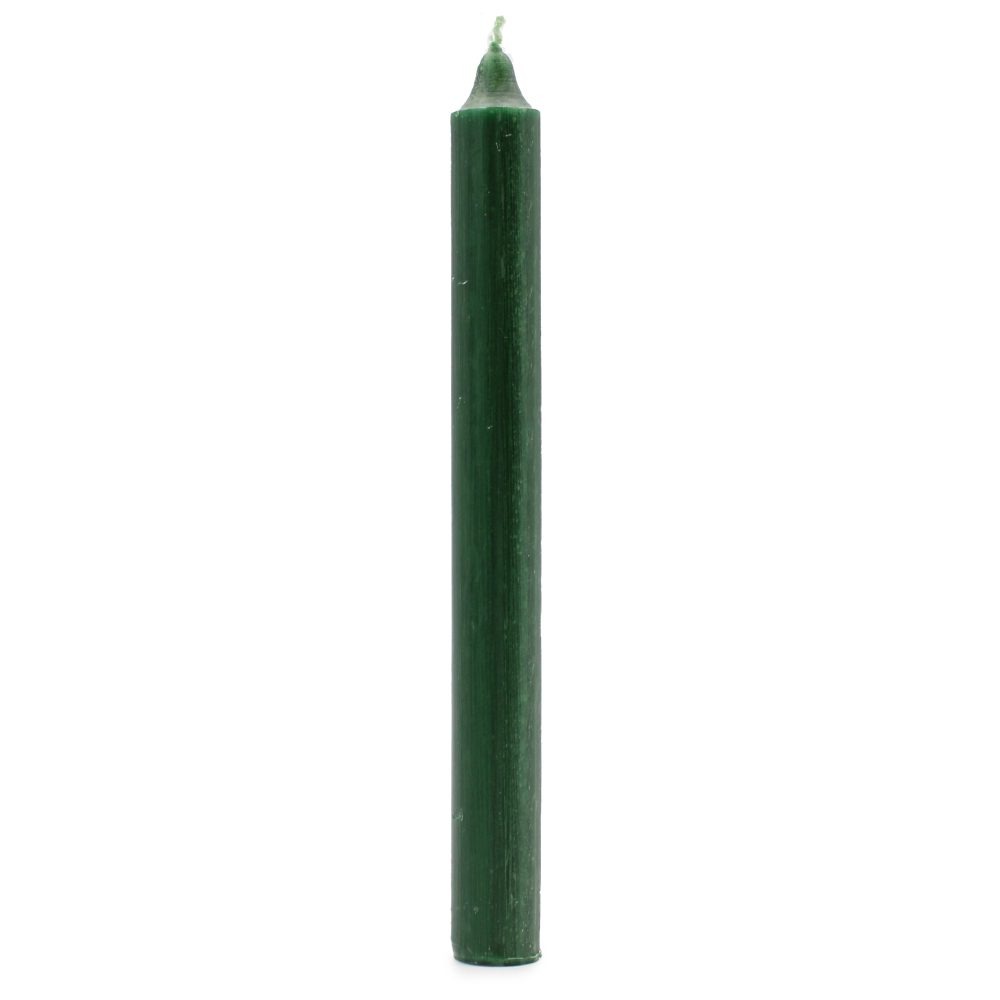 A dark green, cylindrical candle stands upright, unlit, on a plain white surface.