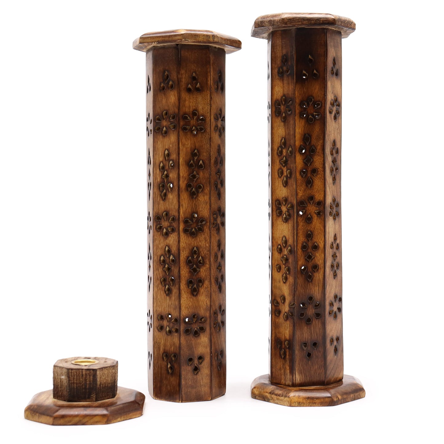 Wooden incense holders stand vertically, featuring intricately carved floral patterns. One holder is closed, and another is open, revealing a separate, circular incense platform on a white background.