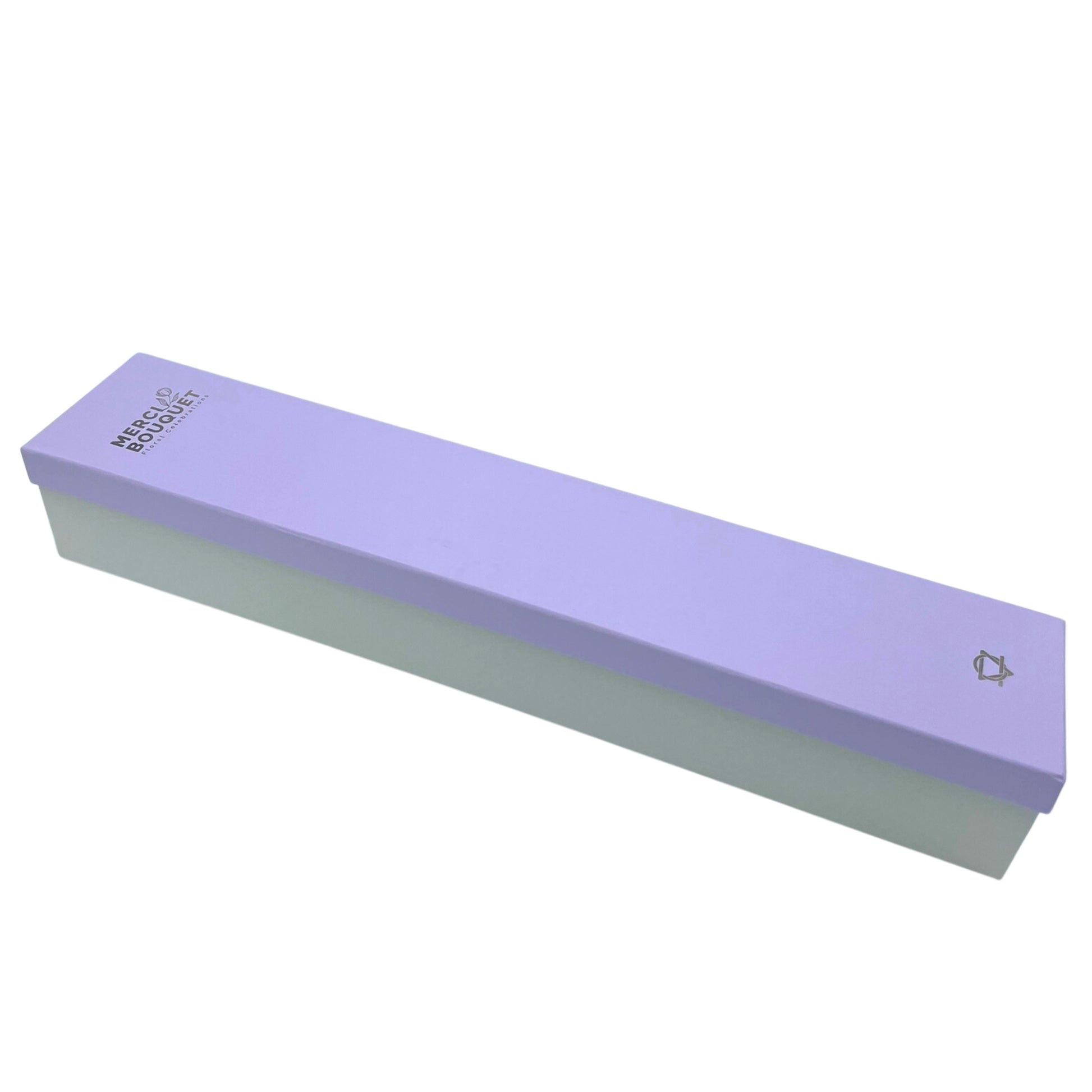 A long, light purple box with a lighter base rests on a white background.  The box displays the text: "MERCI BOUQUET Floral Celebrations".  A small logo is visible on the right.