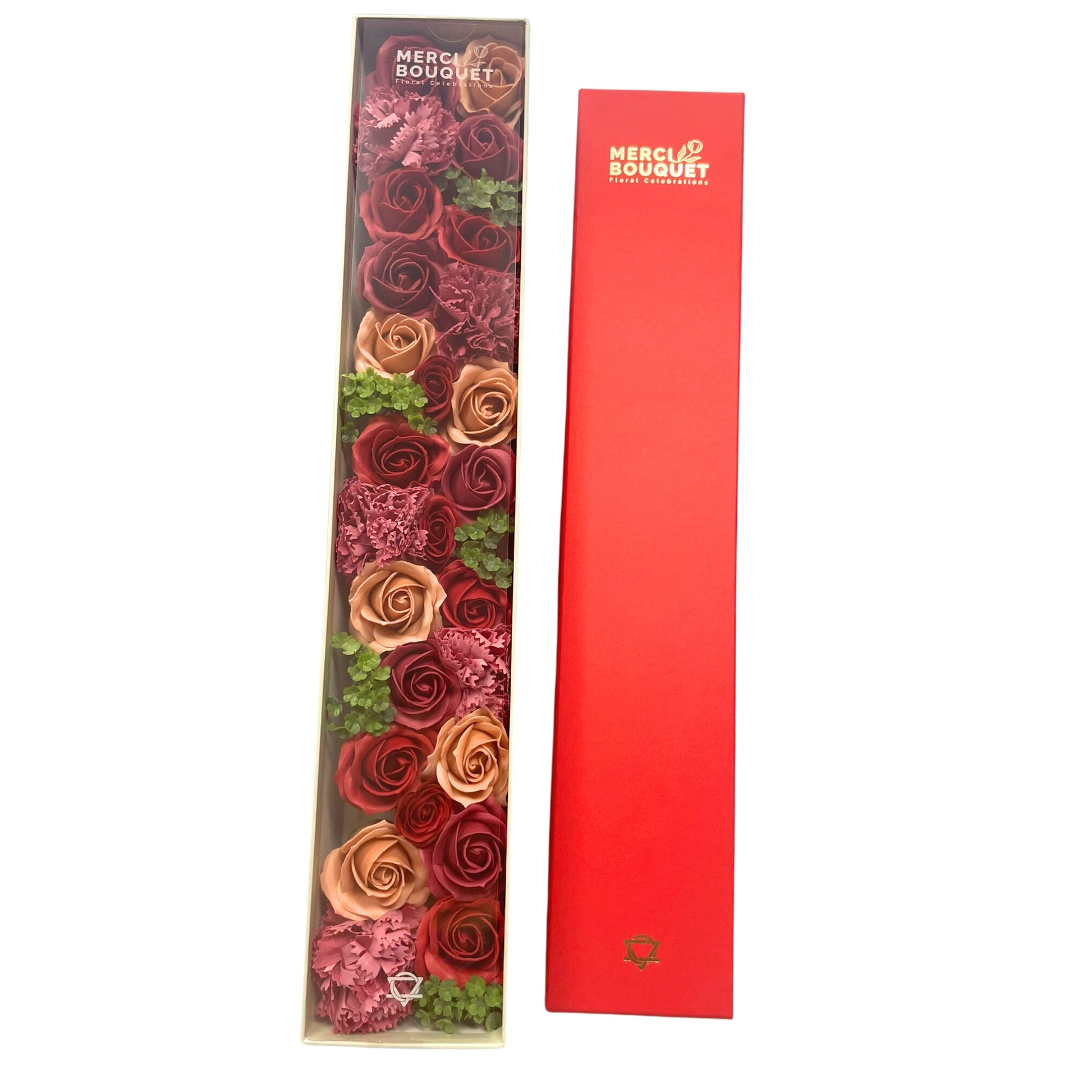A boxed arrangement of roses and carnations, in shades of red and peach, is presented with a matching red sleeve.  "MERCI BOUQUET Floral Celebrations" is printed on both the box and the sleeve.