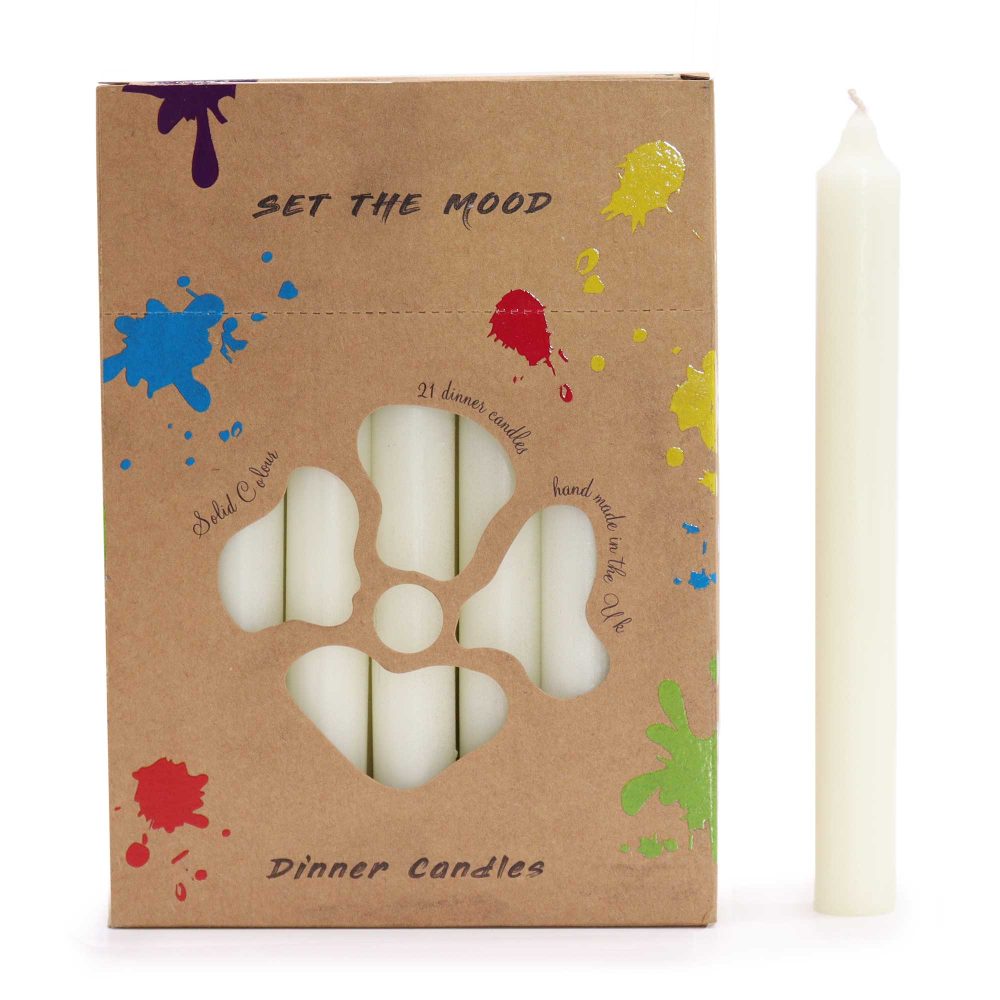 A box of white dinner candles, partially visible through a flower-shaped cutout, sits beside a single, loose candle. The box is decorated with colorful paint splatters and the text "SET THE MOOD", "21 dinner candles", "Solid Colour", "Dinner Candles", and "hand made in the Uk".