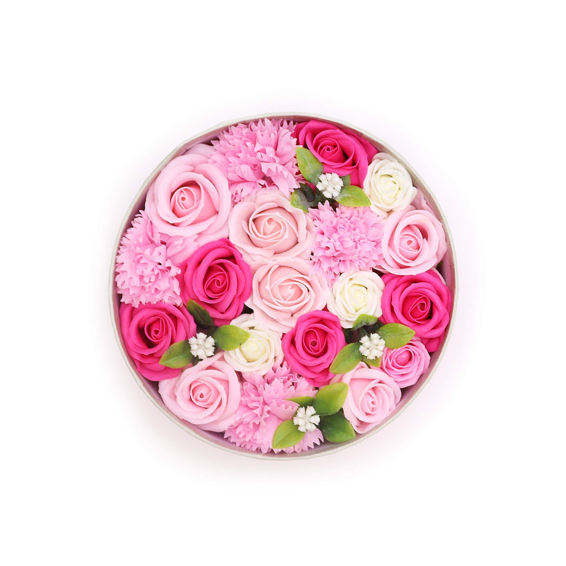 A circular arrangement of pink and white roses and carnations sits in a light gray round box, against a white background.