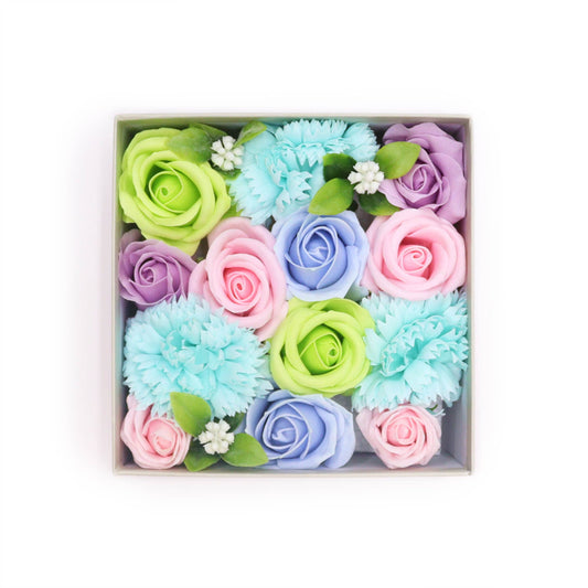 Pastel-colored soap roses and carnations are arranged in a square box.  They are densely packed together.  The box sits on a white background.