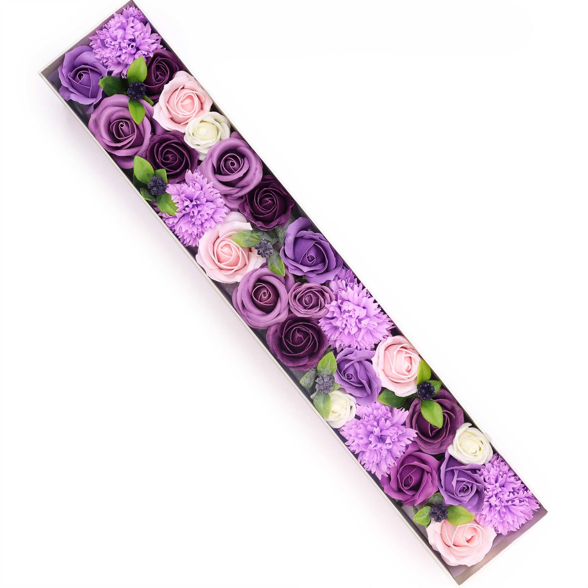 Soap flowers, arranged in a long, rectangular box, are displayed against a white background.  The flowers are various shades of purple, pink, and white.