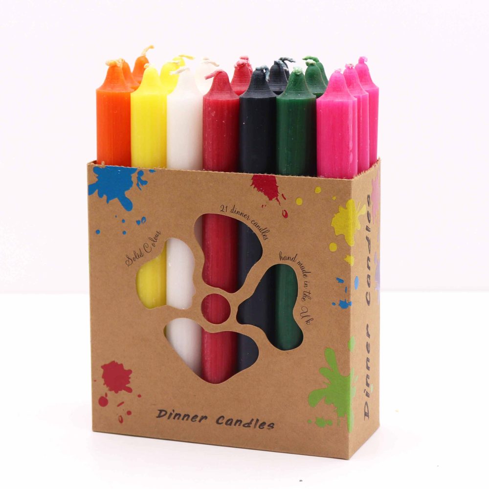 Colorful candles stand in a labeled box that reads "Dinner Candles. Solid Colour. 21 dinner candles, hand made in the U k." Colorful paint splatter decorates the box against a white background.
