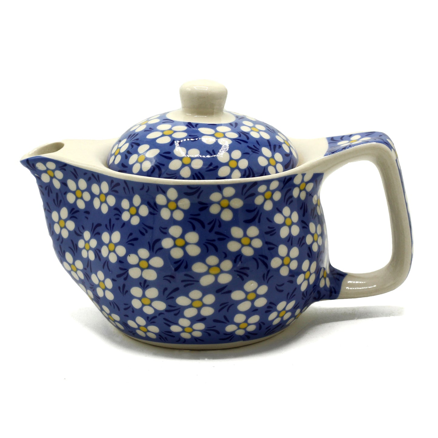 A blue and white floral teapot sits on a white background.  The teapot is decorated with small white flowers and yellow centers on a blue background.  It has a lid and a handle.