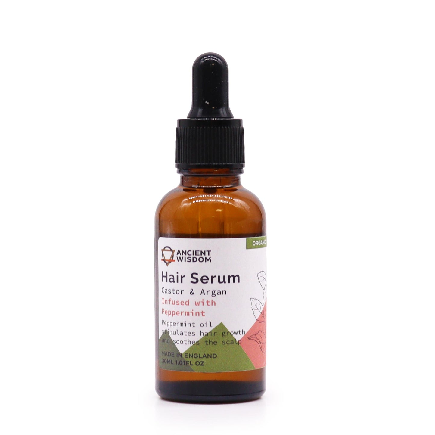 A bottle of "Ancient Wisdom Hair Serum" stands on a white surface. Text on the bottle reads, "Hair Serum, Castor & Argan, Infused with Peppermint...stimulates hair growth and soothes the scalp, MADE IN ENGLAND, 30ML 1.01FL OZ" and "ORGANIC".