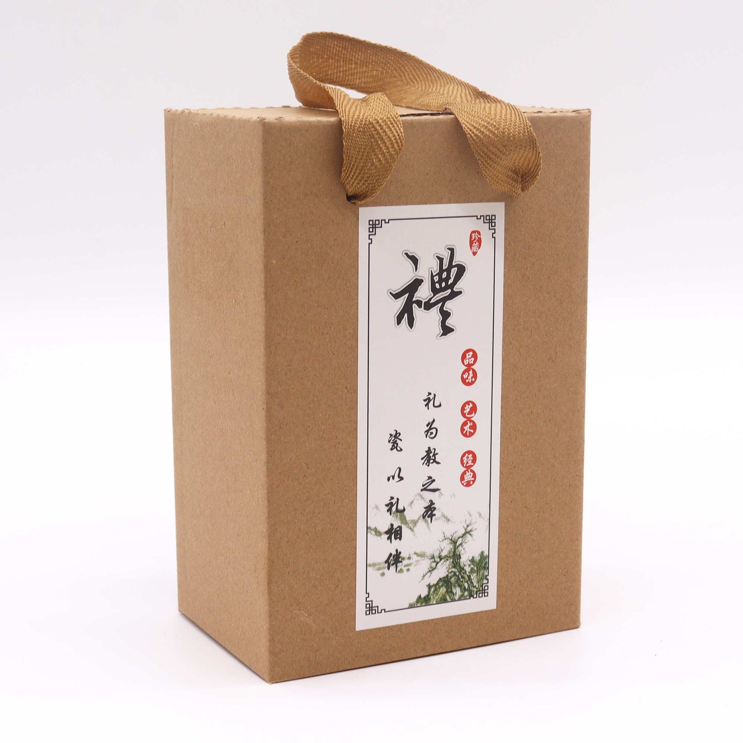A cardboard box with a tan ribbon handle sits on a white background.  The box features a label with Chinese characters;  “禮盒之茶”, and a small illustration.