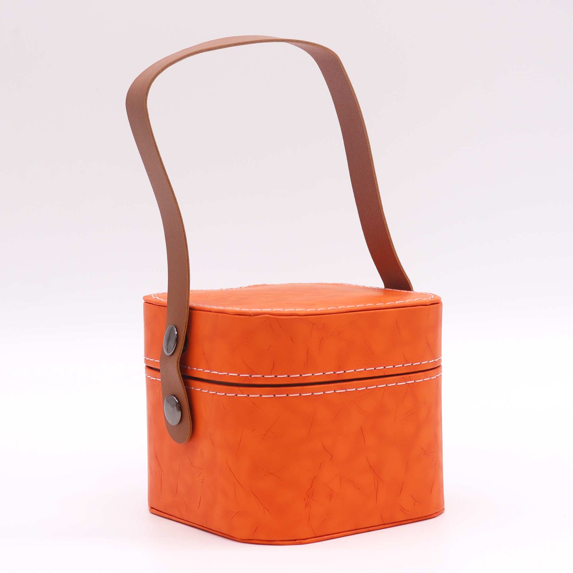 A small orange box with a brown leather handle sits on a white background.