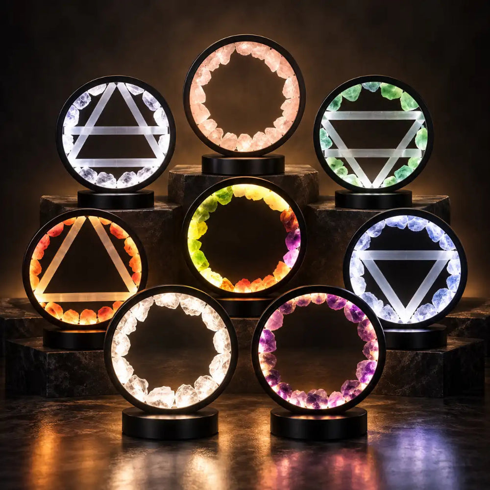 a collection of halo lamps glow in a darkened room, shedding ring shaped soft light into the room in various colours
