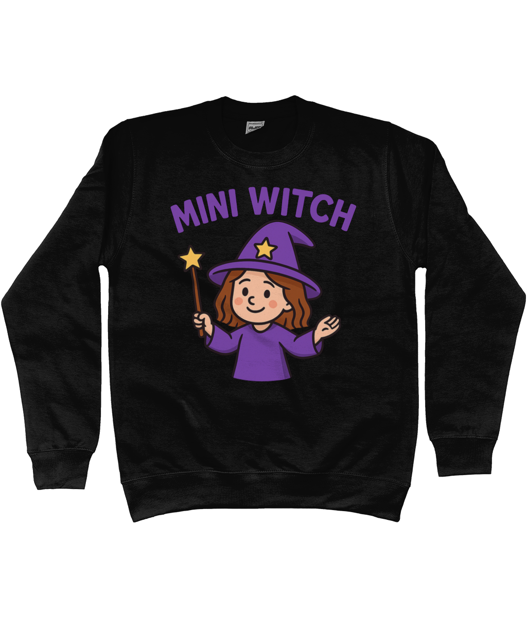 Black sweatshirt with centered graphic reading "MINI WITCH" above a smiling cartoon witch in purple hat and robe holding a star-tipped wand on a white background.