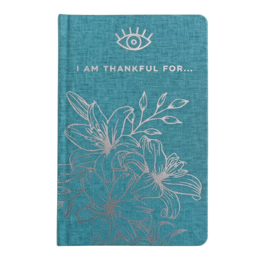 Blue gratitude journal with silver detailing and I Am Thankful For wording on the cover