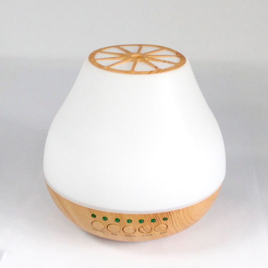 Aromatherapy diffuser, white and wooden, rests on a white surface. The diffuser has an “on/off,” “big,” “small,” “light,” and “time” controls.