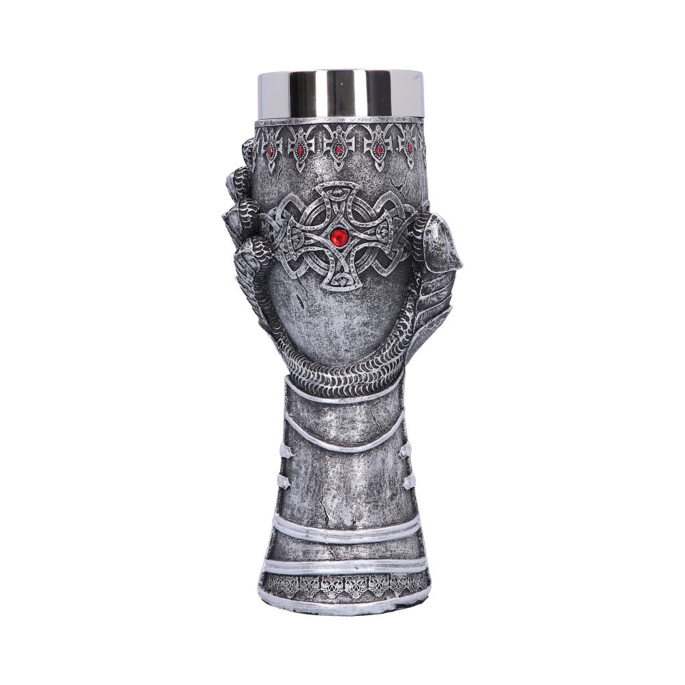 A goblet, featuring a silver cup insert, is gripped by an ornately carved dragon claw and Celtic-style cross, accentuated with red gemstones, against a solid white background.
