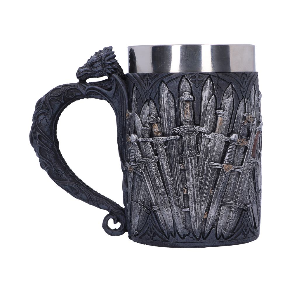 A gray, metallic mug with a silver rim features an embossed design of overlapping swords, and the handle is topped with a dragon's head.