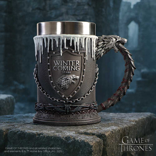 A decorative medieval-style tankard sits on a stone ledge, featuring dripping white icicles, a wolf-head handle and a shield embossed "WINTER IS COMING STARK", plus logos "GAME OF THRONES" and small text "GAME OF THRONES and all related characters and elements © & ™ Home Box Office, Inc. (s25)".