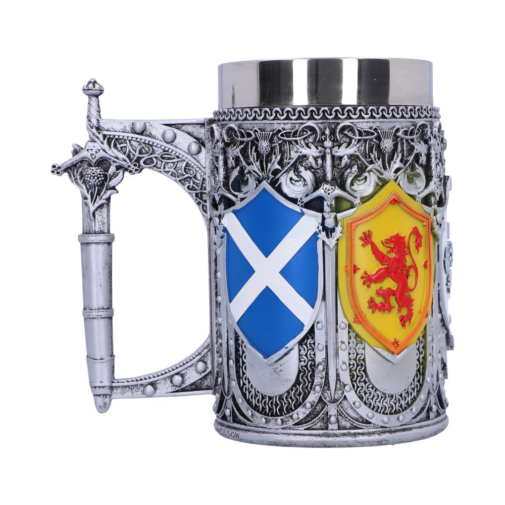 A decorative mug, styled with a silver, detailed exterior, displays the Scottish flag and a yellow shield with a red lion rampant. The handle is formed like a sword.