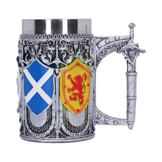 A silver, decorative stein features a saltire on a shield and a red lion rampant on a yellow shield. The handle resembles the hilt of a sword, and the stein stands on a white surface.