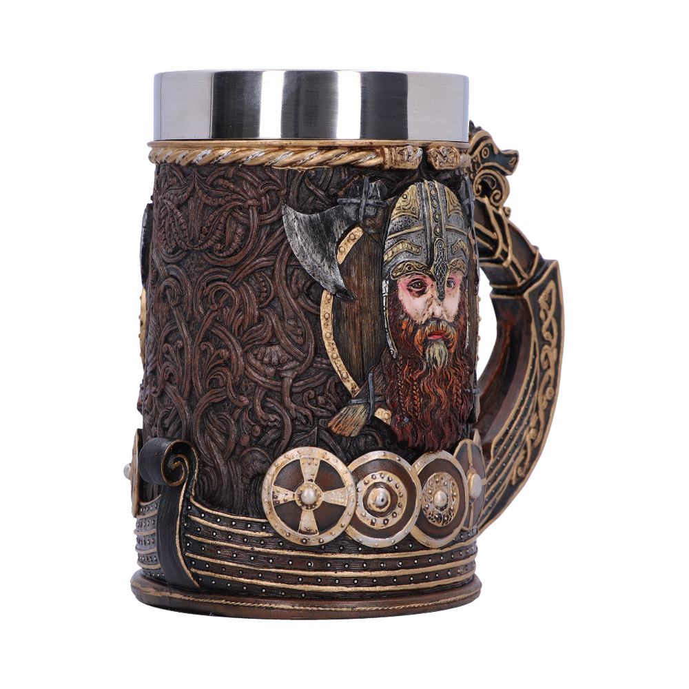A brown Viking beer stein, accented with gold and a stainless steel rim, features detailed carvings of a warrior's head, an axe, shields, and a Viking longship.