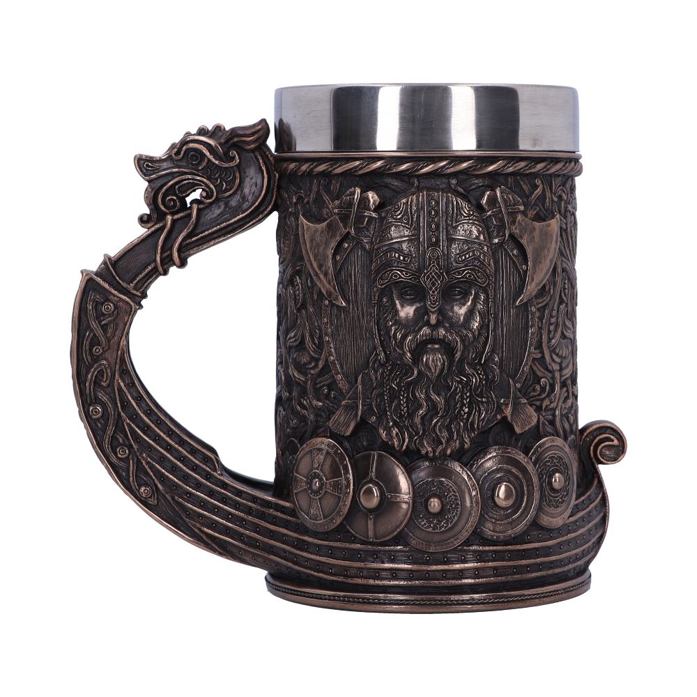 A bronze-colored beer mug, detailed with a Viking face and shields, is set against a white background. The mug’s handle is shaped like a dragon-headed ship.