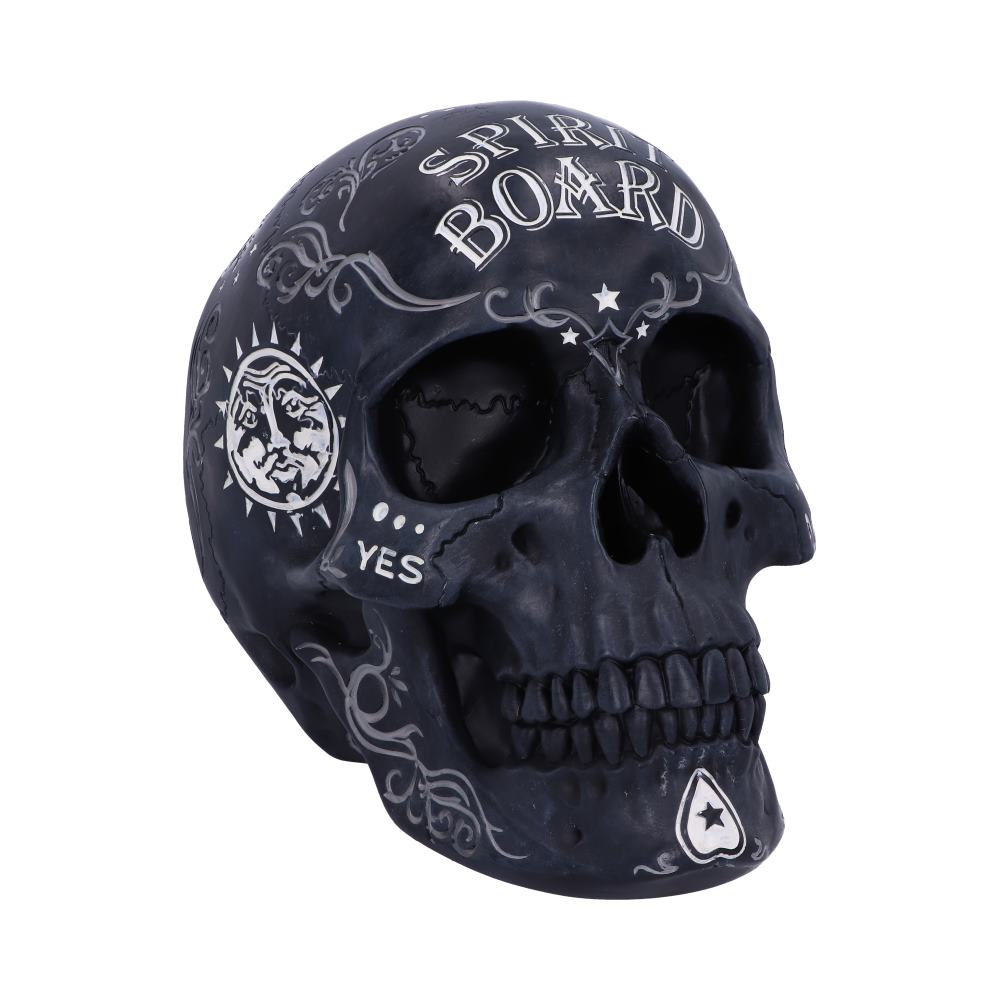 A dark, decorative skull features white text and designs, including "SPIRIT BOARD," "YES," a sun and moon emblem, and swirling patterns, against a plain white background.