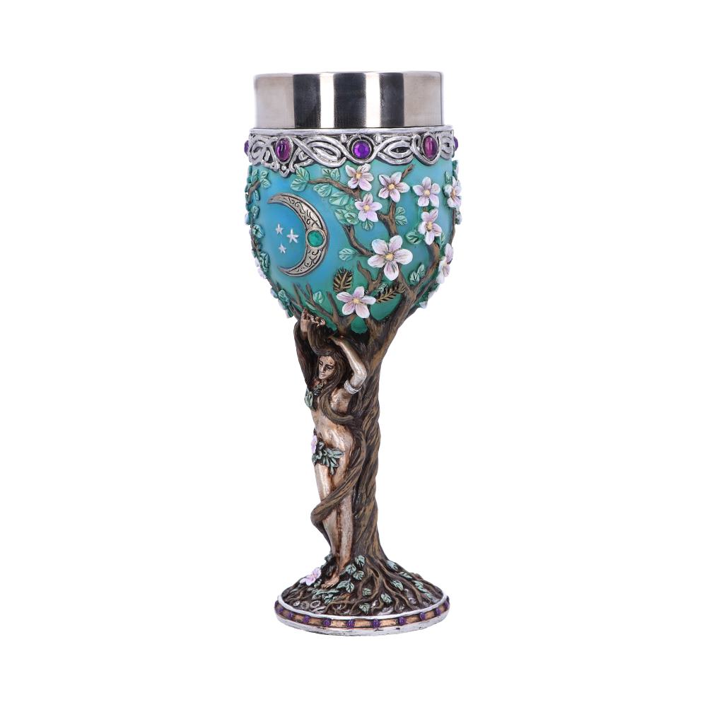 The ornamental goblet has a silver-colored metal cup held up by a light brown tree with a woman intertwined in it; a blue moon and stars, and pink flowers decorate the goblet's body.