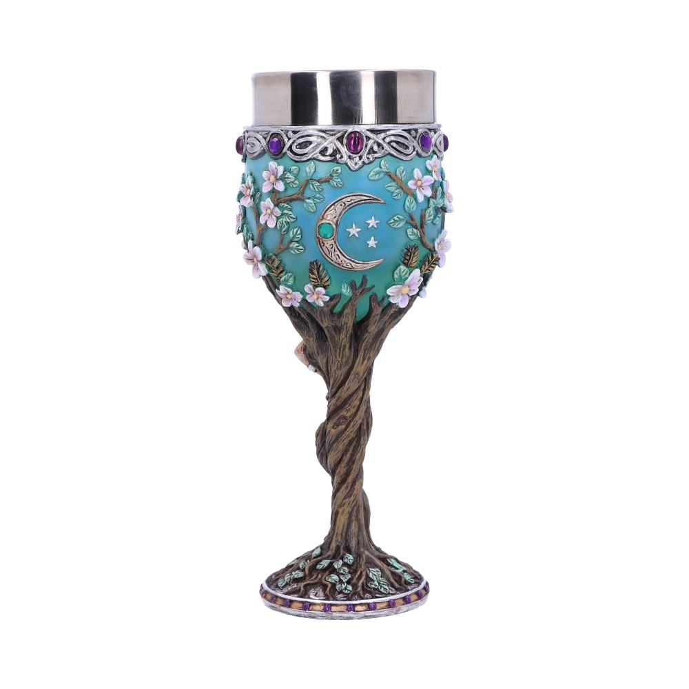 A goblet, decorated with a blue moon and stars, is displayed upright on a white background. Its stem is sculpted like a twisting tree, and white flowers adorn the cup.