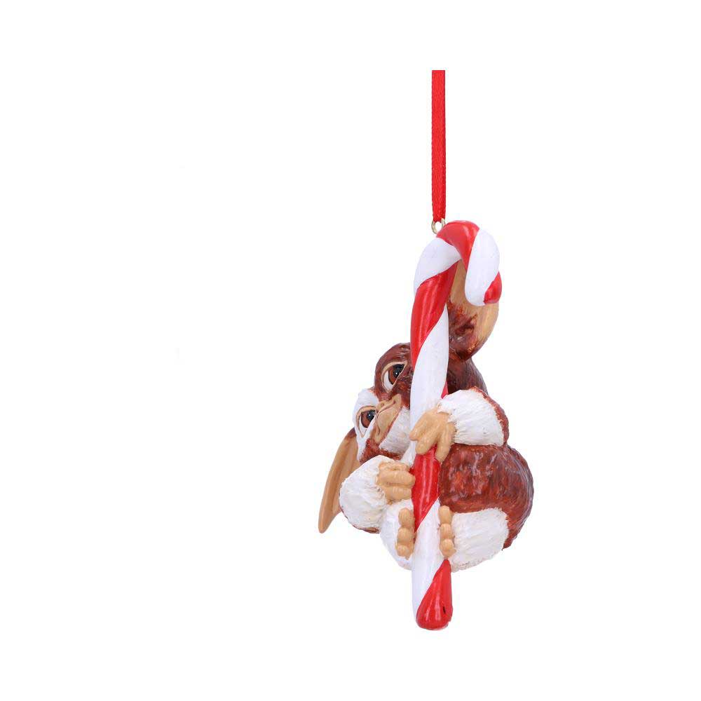 A small creature figurine clings to a large red-and-white striped candy cane, suspended from a red ribbon against a plain white background.