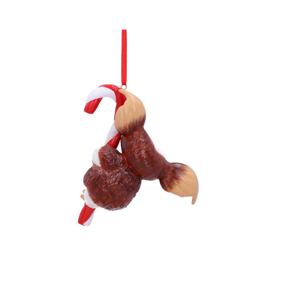 A brown squirrel ornament hangs upside down on a red and white candy cane, suspended by a red ribbon against a plain white background.
