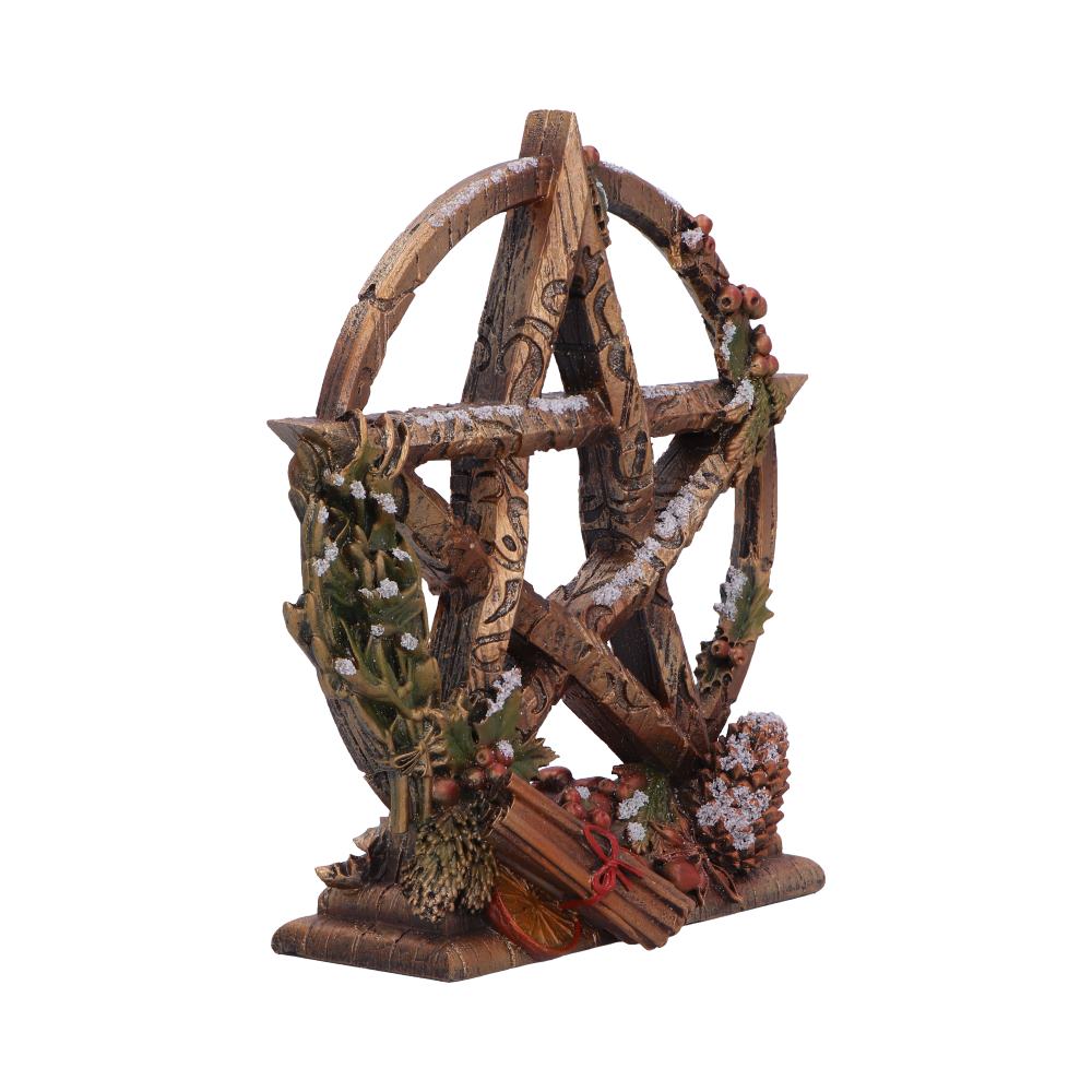 A pentagram stands on a base.  It is made of wood, decorated with greenery and winter elements.  The piece sits against a white background.