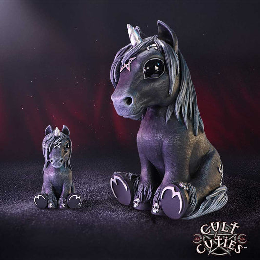 A dark purple unicorn figurine sits facing forward with a smaller matching unicorn beside it, decorated with star and skull motifs against a glittery purple black backdrop; text: CULT CUTIES™