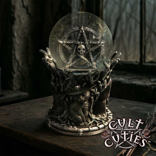 Cult Cuties Circle of Mischief Snow Globe by Nemesis Now with Zefur, Malpuss and Pawzuph around a black tree base, pentagram, skull and swirling snow