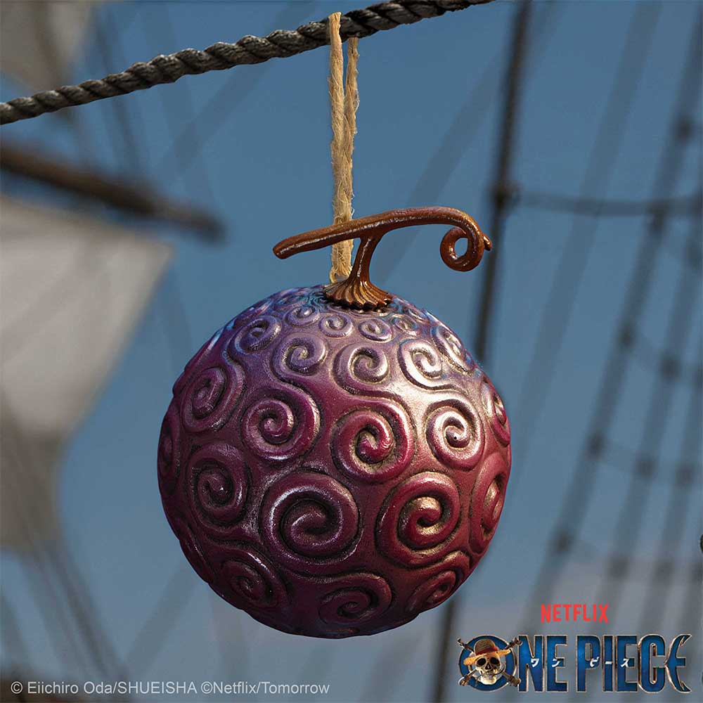 Devil Fruit ornament hanging from a rope on a blue One Piece themed background