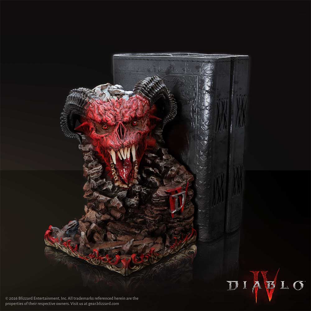 Diablo IV Minion of Hell Bookend - shown beside a dark book prop with the horned minion facing outward