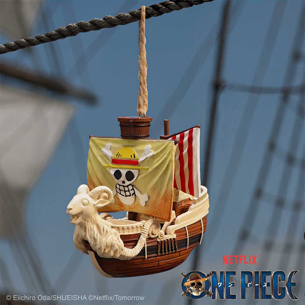 Going Merry ornament hanging from a rope on a blue One Piece themed background