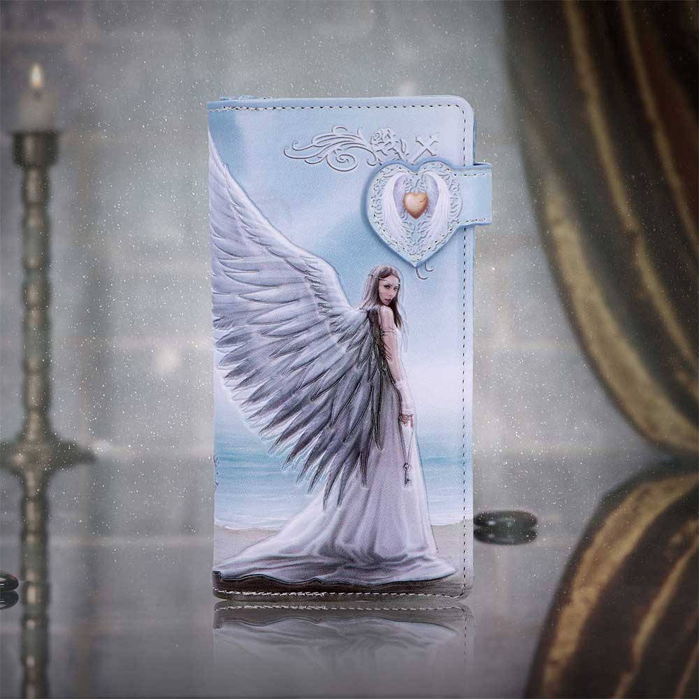 Anne Stokes Spirit Guide Embossed Purse - displayed upright beside decorative props with the angel artwork facing forward